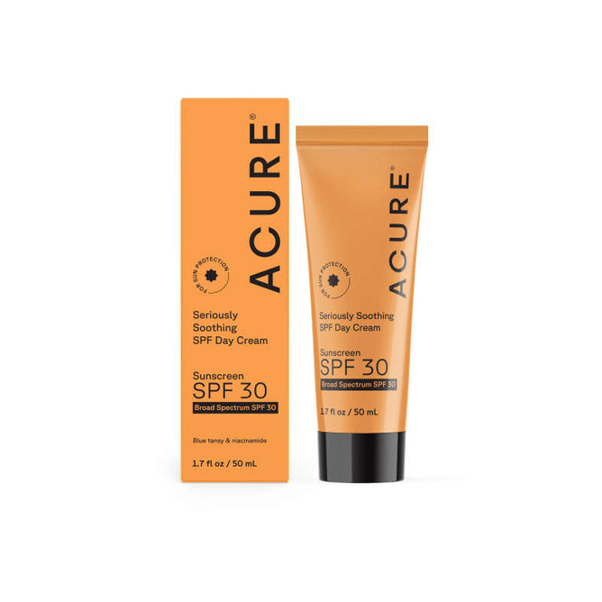 A tube and box of Acures Seriously Soothing Day Cream - SPF 30, enriched with blue tansy for calming, are shown. The orange packaging with black text highlights Sunscreen SPF 30 and Broad Spectrum protection. Tube size is 1.7 fl oz / 50 mL.