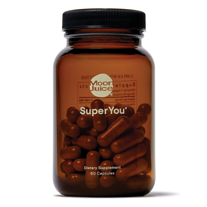 The brown Moon Juice SuperYou bottle contains 60 dietary supplement capsules for stress management, energy, mood, and focus. The black screw-on lid reveals dark contents in transparent capsules enriched with adaptogens to aid in cortisol reduction and foster a balanced lifestyle.