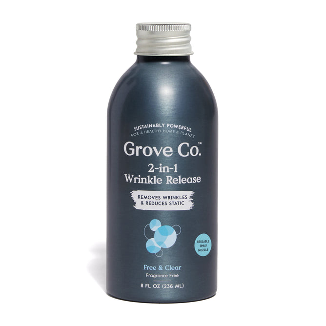 A silver bottle of Grove Co. 2-in-1 Wrinkle Release Refill spray is featured with a plastic-free design, highlighting its ability to remove wrinkles and reduce static. This fragrance-free product comes in an 8 fl oz (236 mL) size.