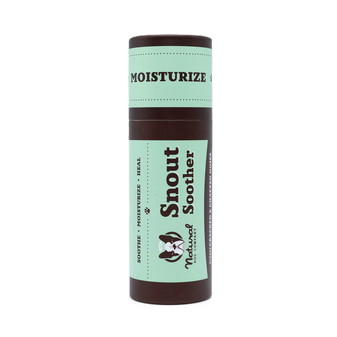 Snout Soother by Natural Dog Company is a cylindrical tube with a green and brown design, designed to soothe, moisturize, and heal dry cracked snouts with natural ingredients.