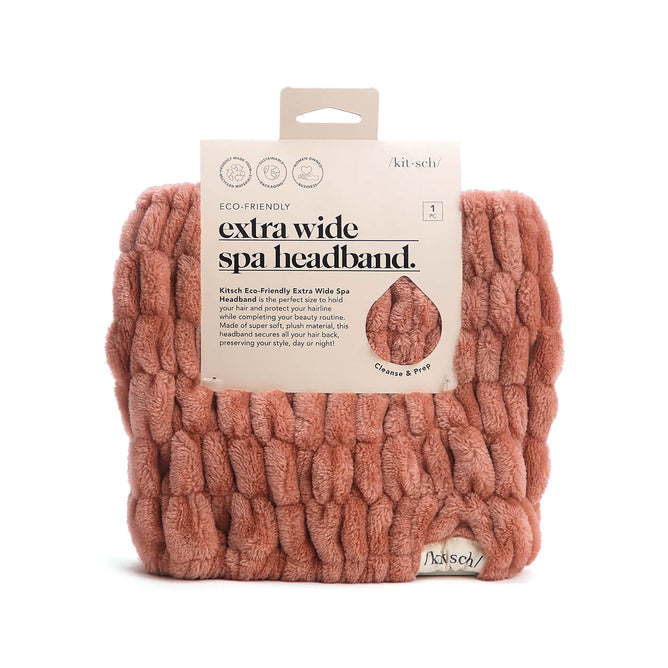 Kitschs Extra Wide Spa Headband in pink, showcased in packaging, is made from eco-friendly recycled polyester. This plush accessory is perfect for enhancing your hair care routine and can be used during face washing, skincare sessions, or makeup application.