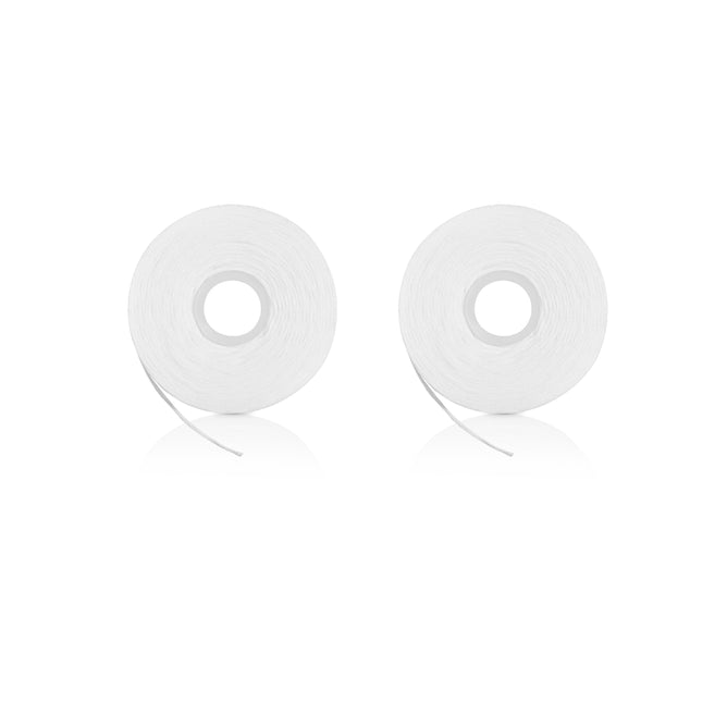 Two Davids Expanding Dental Floss refills lie side by side on a white background, resembling rolls of transparent adhesive tape. Each refill has a smooth, glossy finish with the floss slightly extended from the inner circle.