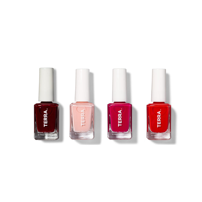 Four vegan, cruelty-free nail polishes from the Terra Beauty Bars Pink+Red Curated Nail Collection are lined up against a white background. Ranging from dark red to vibrant pink, each bottle features a white cap and displays the word TERRA.