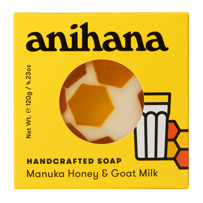 The Anihana handcrafted soap package, featuring a yellow design and honeycomb/milk glass illustrations, showcases the nourishing ingredients with a cut-out. Labeled Manuka Honey & Goat Milk, it weighs 120g (4.23oz) and highlights sustainability.