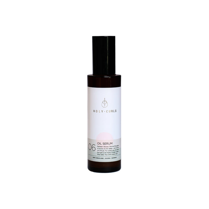 A bottle of Holy Curls Oil Serum featuring a black cap and a white label focuses on its vegan, frizz-controlling formula. Ideal for defining and nourishing curls.