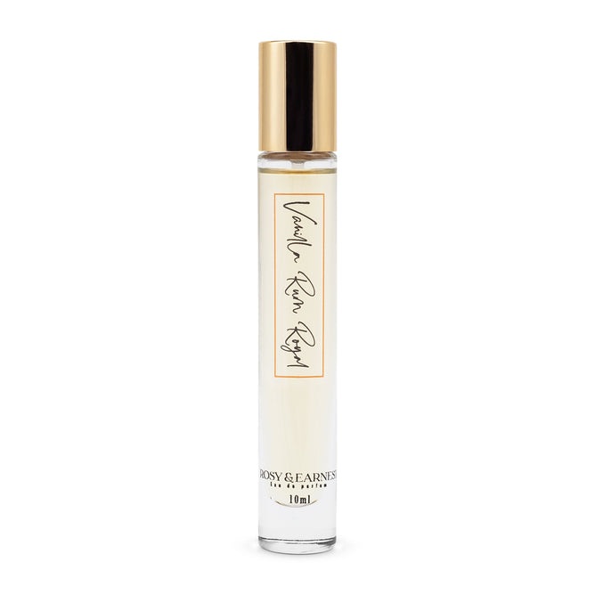 The Vanilla Rum Royal perfume by Rosy & Earnest comes in a simple, elegant cylindrical bottle with a 10ml capacity, featuring a light-hued liquid and a gold cap for a premium experience.