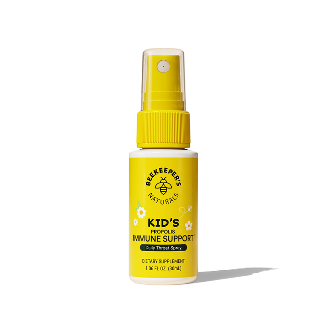A yellow spray bottle labeled Kids Propolis Immune Support Throat Spray from Beekeepers Naturals, 1.06 fl oz (30 ml), features bee and honeycomb designs on the label for this daily dietary supplement.