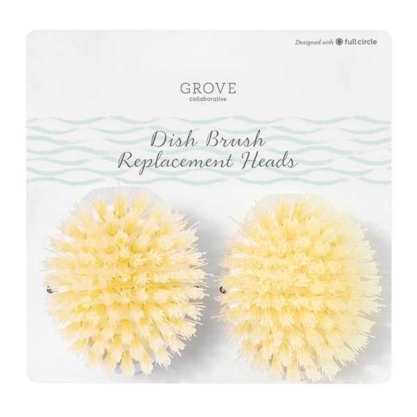 The packaging features two yellow Dish Brush Replacement Heads by Grove Co., showcasing essential cleaning tools with circular designs and soft bristles, set on a white background with a light wave pattern and text.