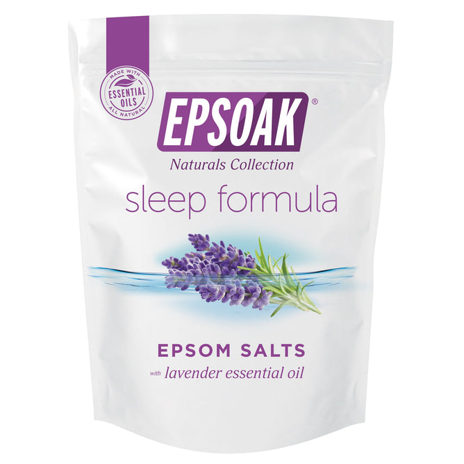 The Epsoak Everyday Sleep Formula by San Francisco Salt Co comes in white packaging adorned with a Naturals Collection label, highlighting its lavender essential oil component. It features a lavender illustration and promises a soothing Epsom salt soak enhanced with essential oils.