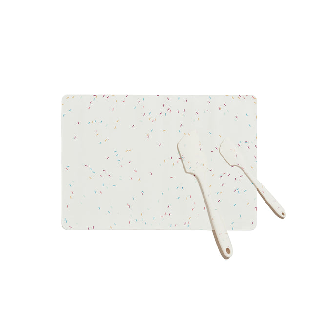 A 3-Piece Baking Set by GIR includes a white cutting board with colorful specks and two mini spatulas, all isolated on a plain white background.