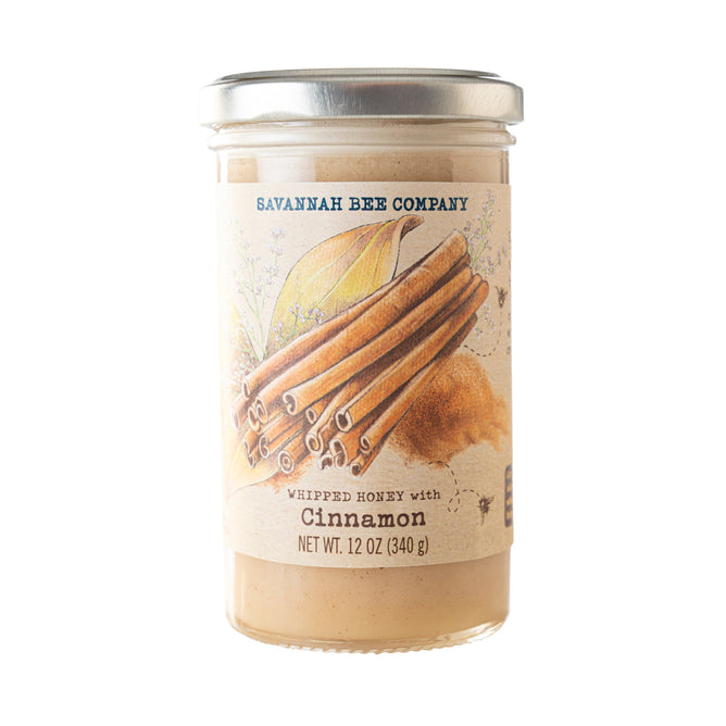 Savannah Bee Companys Whipped Honey with Cinnamon comes in a 12 oz jar with a label featuring organic Ceylon cinnamon sticks and honeycomb, offering an exquisite blend of sweet and spice.