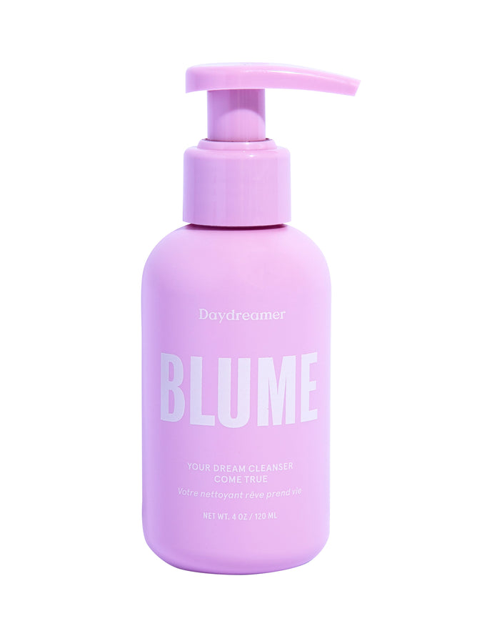 A 4 oz pink pump bottle labeled Daydreamer by Blume Skincare reads Your Dream Cleanser Come True, offering a creamy cleanser enriched with soothing plant extracts for a hydrating experience.
