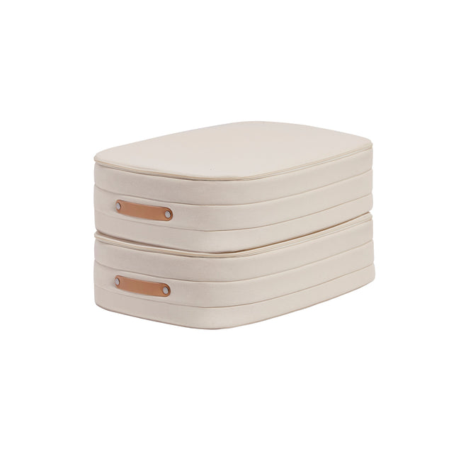 Open Spaces Underbed Storage boxes are stacked in beige fabric with tan leather handles, crafted from natural canvas for breathable protection. Their minimalist design on a white background highlights their rectangular shape and clean seams—perfect sleek storage solutions.