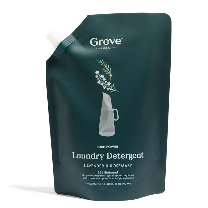 A dark green resealable pouch of Grove Co.s Pure Power Liquid Laundry Detergent, featuring lavender and rosemary scent with plant-based agents. The front shows a flower pitcher sketch. The pouch holds 24 oz, suitable for about 33 loads.