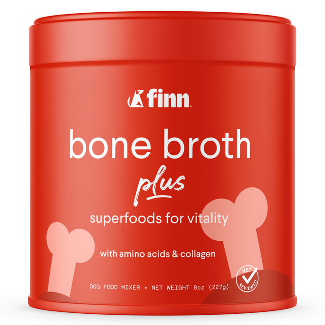A red tin of Bone Broth Plus by Finn, featuring white text and bone graphics, offers superfoods for vitality with amino acids and collagen, along with a vet-approved seal. This 8 oz (227g) dog meal topper enhances your pets nutrition.