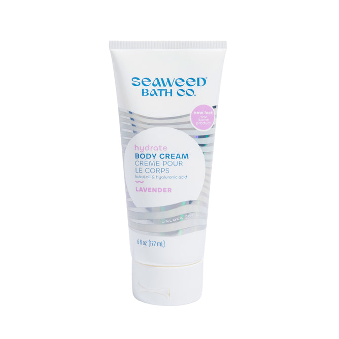 The Seaweed Bath Cos 6 fl oz Hydrating Body Cream showcases its organic skin care benefits in a white tube with a purple cap, highlighting ingredients like kukui oil and hyaluronic acid for a perfect hydrating experience.