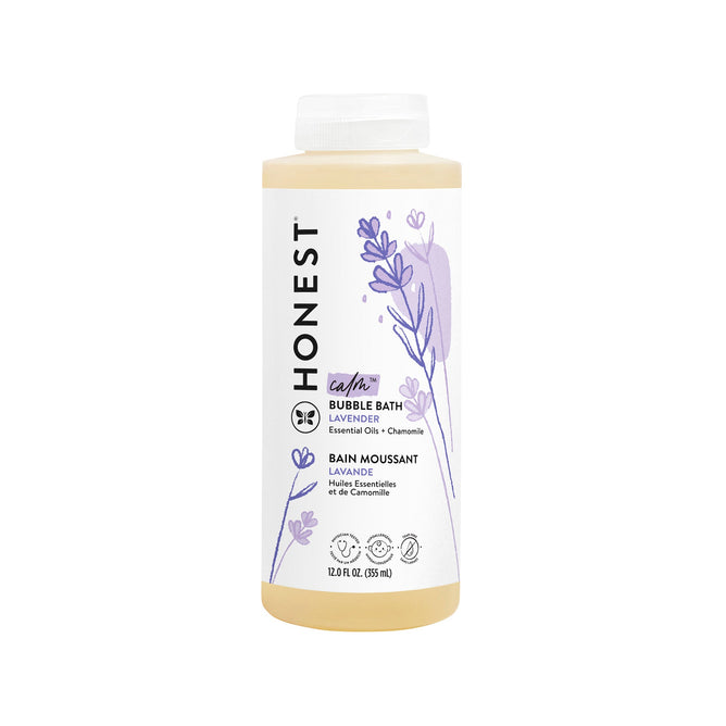 A 12 fl oz (355 ml) bottle of The Honest Companys Bubble Bath features lavender essential oils and chamomile extract. The label has purple lavender illustrations on a white background for a calming bathing experience.