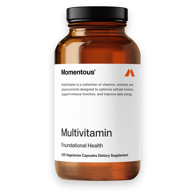A brown pill bottle labeled Momentous Essential Multivitamin rests against a white background. Containing 120 vegetarian capsules, it is filled with vitamins, minerals, and essential phytonutrients to support cellular and immune function while boosting daily energy and overall health.