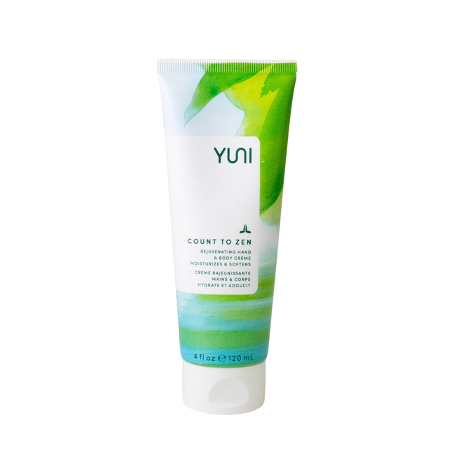 The 120 mL Count to Zen - Rejuvenating Hand & Body Crème by YUNI features a white tube with green and blue abstract designs. This vegan cream has natural ingredients and black text promising gentle skin nourishment.