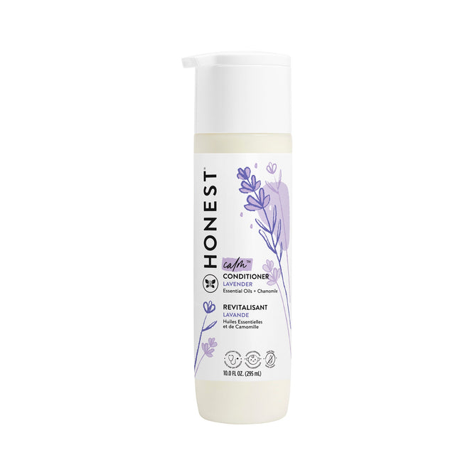 A 10.0 FL OZ bottle of The Honest Company silicone-free lavender conditioner with jojoba oil, featuring a pump dispenser and a white and purple label adorned with lavender sprigs, reads essential oils + chamomile.