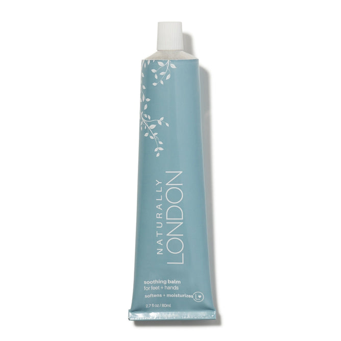 A blue squeeze tube from Naturally London, labeled Soothing Balm for Feet & Hands, is shown on a white background. The moisturizing balm soothes dry skin with Calendula and Baobab oil to soften and hydrate. A small leaf graphic adorns the tube.