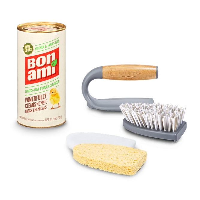 The Fresh Start Bathroom Bundle by Grove Collaborative includes a can of Bon Ami powder cleanser with a chick on the label, emphasizing gentle cleaning without harsh chemicals. It also contains a sponge, white scrub pad, and an eco-friendly brush made from recycled plastic with gray bristles.