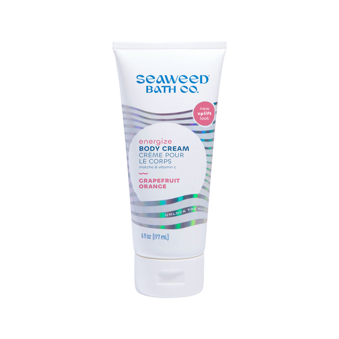 A 6 fl oz tube of The Seaweed Bath Co. Energizing Body Cream, featuring matcha and a Grapefruit and Orange scent, has a wave pattern label with English and French text, plus a new uplift look circle.