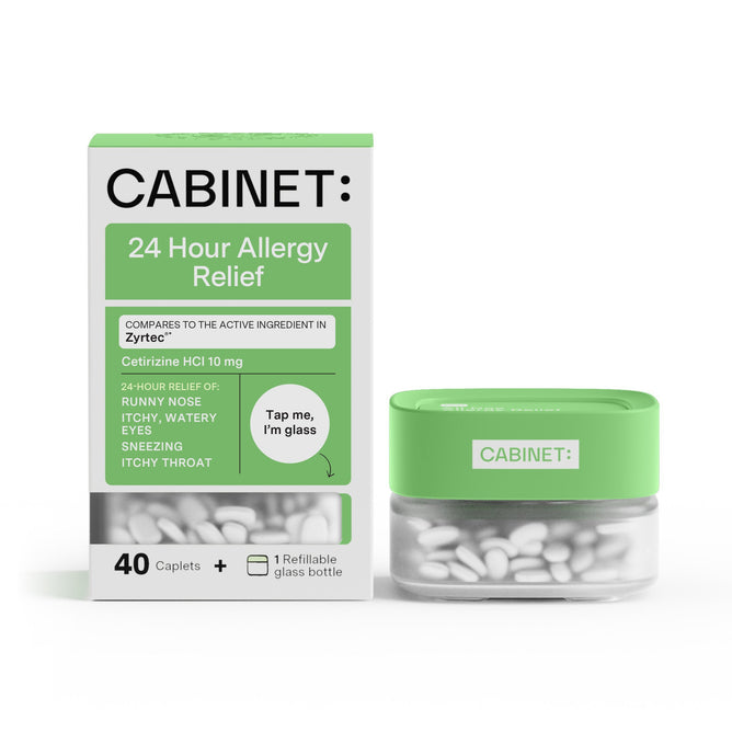 A green and white box labeled Cabinet Health: All Day Allergy Relief - Cetirizine HCl 10 mg containing 40 caplets is beside a green-lidded glass bottle. The packaging highlights Cetirizine HCl, which addresses symptoms like runny nose and itchy eyes.