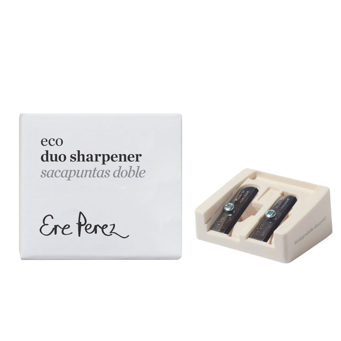 The Eco Sharpener by Ere Perez is a white rectangular duo sharpener with two carbon steel blades, displayed next to its eco-friendly packaging labeled eco duo sharpener sacapuntas doble.