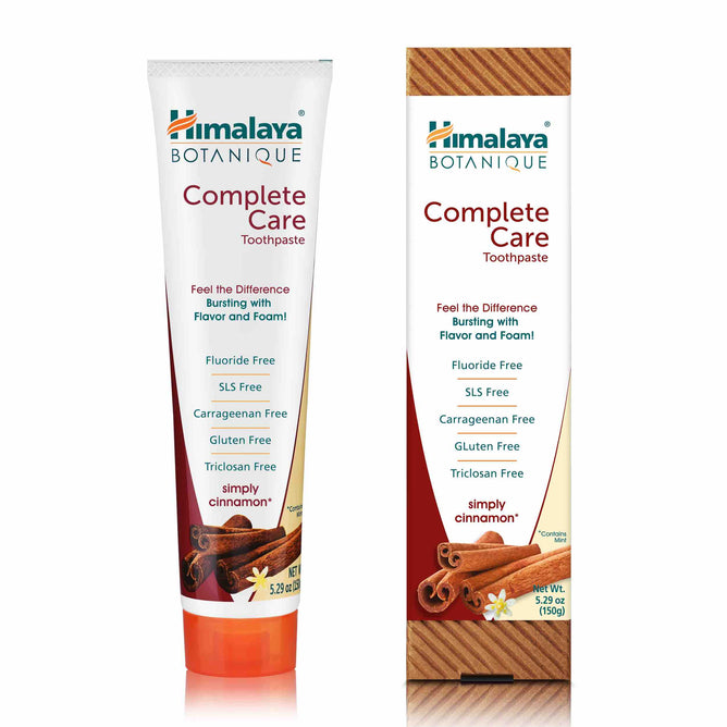 A tube and box of Himalaya Complete Care Toothpaste, labeled Simply Cinnamon, featuring fluoride-free, carrageenan-free, SLS-free, gluten-free, and triclosan-free packaging enhanced with neem and pomegranate.