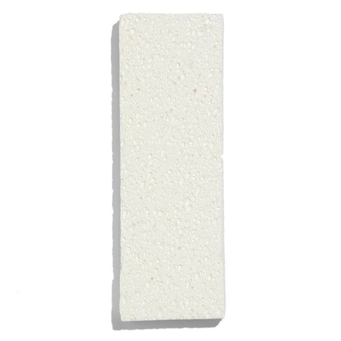 The Grove Co. Wet Mop Attachment Refill is displayed on a white background, featuring a textured and slightly uneven surface that resembles a natural cellulose sponge, highlighting its ultra-absorbent capabilities.