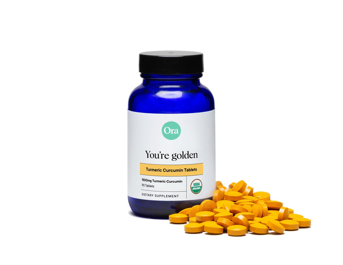 A blue bottle of Ora Organics Turmeric Curcumin Pills with Black Pepper offers 90 organic tablets, each providing 1000mg for enhanced wellness. The sleek design features scattered golden tablets.