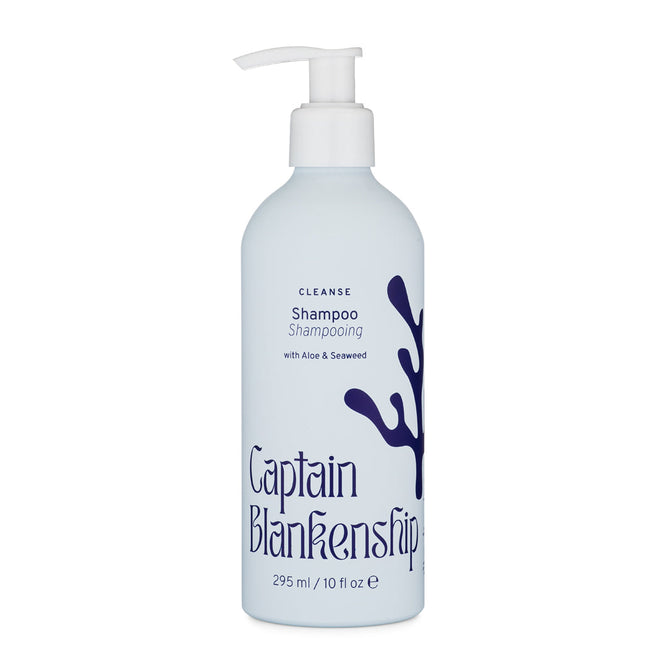 The Captain Blankenship Cleanse Shampoo features a light blue bottle with a pump dispenser and a seaweed illustration on the label. It contains organic aloe vera, seaweed, and coconut-derived surfactants. Available in 295 ml / 10 fl oz capacity.