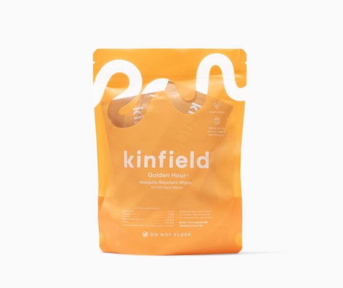 Kinfields Golden Hour Mosquito Repellent Wipes, in a wavy white-designed orange pack, contain 12 plant-based wipes made with Indonesian citronella. They are labeled DO NOT FLUSH and crafted from recycled materials—a perfect travel-friendly companion.