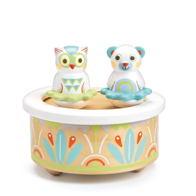 The Babys First Music Box by DJECO is a delightful toddler gift, crafted from FSC® Certified Wood. It features a colorful owl and bear on top, with the base adorned in pastel floral and geometric patterns for a whimsical touch.
