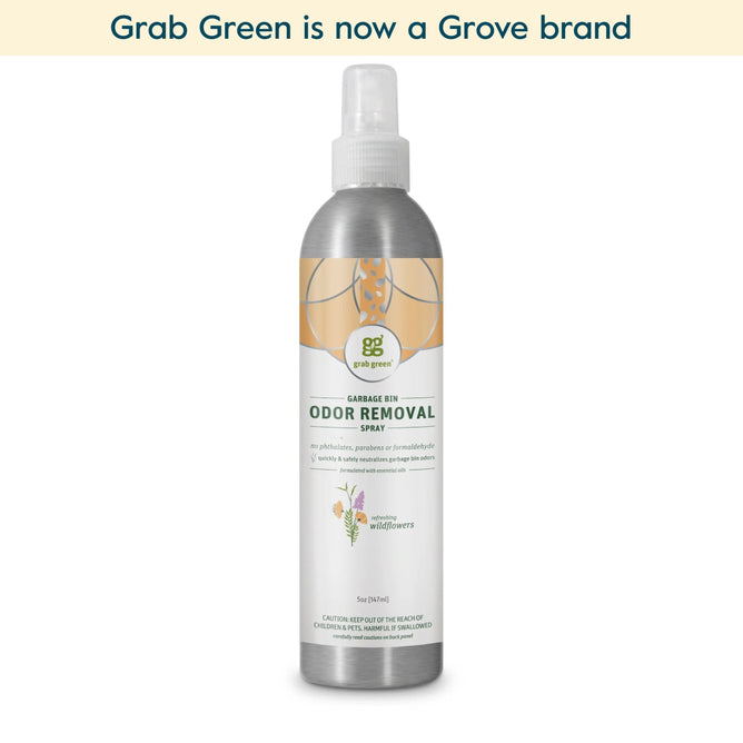 A spray bottle of grab green Garbage Pail Odor Removal Spray - Wild Flowers (Coming Soon!), featuring essential oils and a white and silver design. Text above reads, grab green is now a Grove brand.
