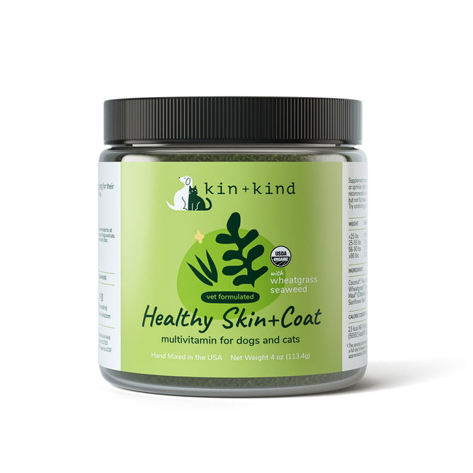 The kin+kind Healthy Skin and Coat Powder Supplement for Dogs and Cats has a green label with leaf graphics, boasting supergreens like wheatgrass and seaweed. The USDA organic and vet-formulated icons denote quality. Net weight: 4 oz (113.4g).