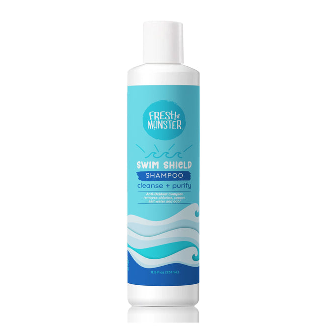 A white 8.5 fl oz (251 mL) bottle of Fresh Monster Swim Shield Chlorine Removal Shampoo with a blue wave label, featuring “cleanse + purify” and “Anti-Chlorine Complex.” Safe for kids, removes chlorine after swimming.