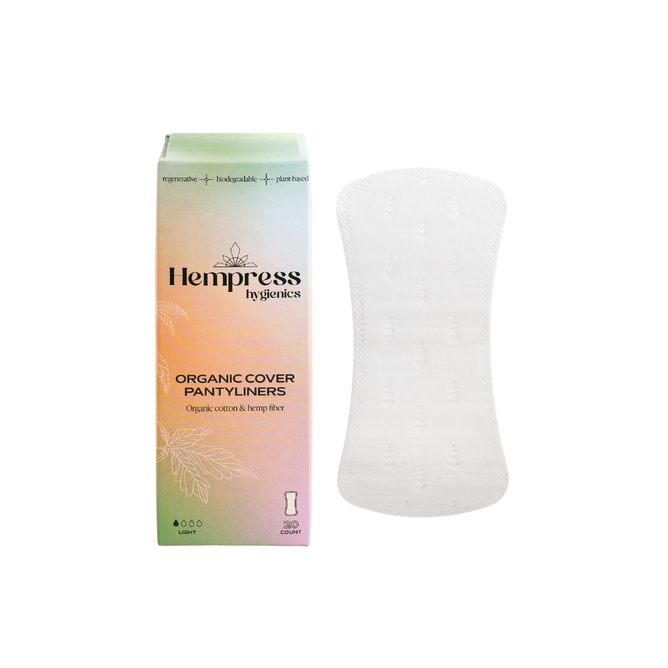 A box of Hempress Hygienics Hemp Pantyliners sits next to a single white pantyliner. The pastel packaging highlights their vegan, plant-based materials and non-toxic adhesive for safe, sustainable protection.