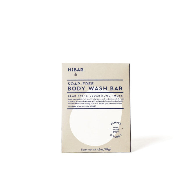 The HiBAR Clarify Body Wash Bar features a cedarwood + moss scent, comes in minimalist beige packaging with blue text and circular graphic, is pH-balanced and non-comedogenic, and comes in a 4oz (113g) bar.
