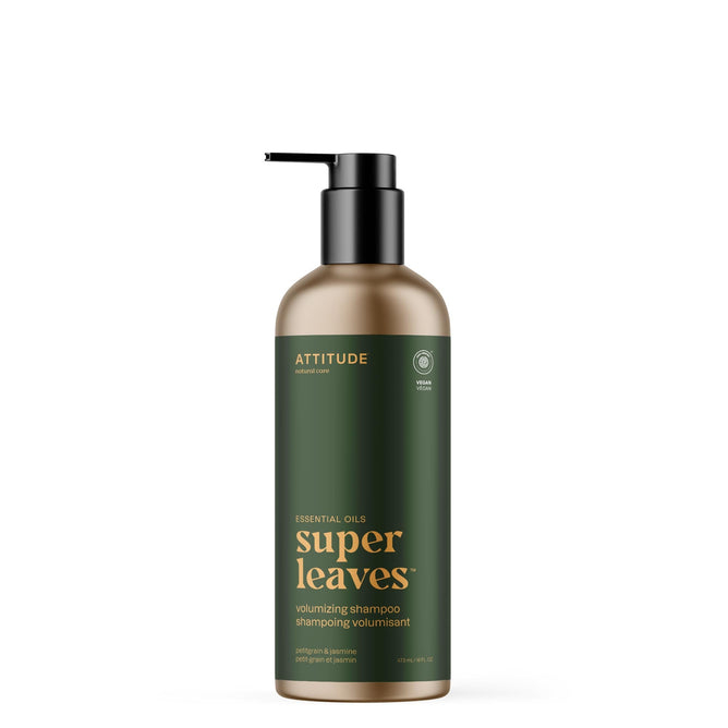 A green bottle of ATTITUDE super leaves essential oils Shampoo Volumizing with a black pump and gold/white text, highlighting volumizing benefits and naturally sourced ingredients like Petitgrain & Jasmine.