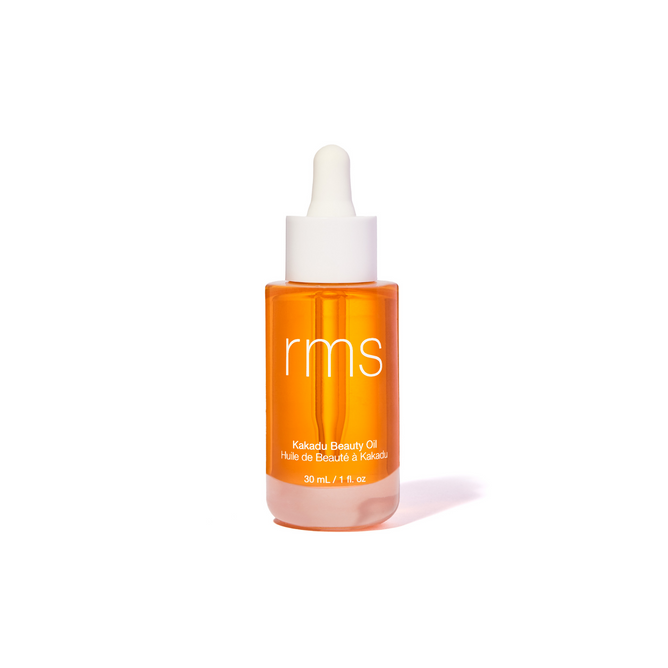 A clear bottle of RMS Beauty Kakadu Beauty Oil with a white dropper cap sits against a plain white background. The label reads Kakadu Beauty Oil, 30 ml / 1.1 fl oz and highlights its vitamin C-rich Kakadu Plum infusion.