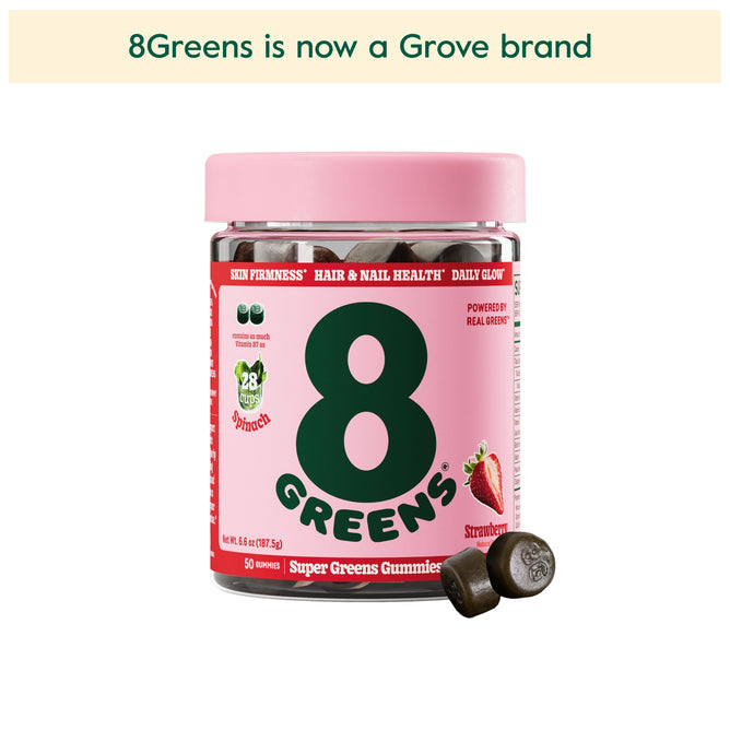 A pink container of 8Greens Super Greens Gummies - Beauty in strawberry flavor features two gummies up front. The text above states 8Greens is now a Grove brand. The label highlights benefits like improved skin firmness, and hair and nail health, promising a daily glow with real greens.