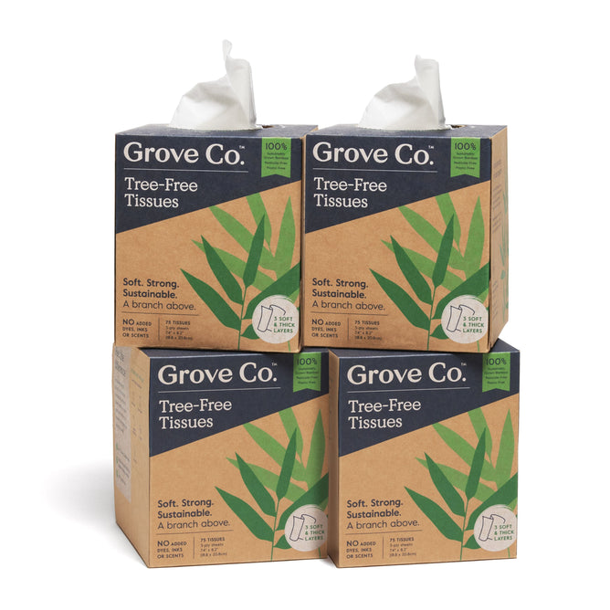A set of four Grove Co. Tree-Free Facial Tissue boxes, made from 100% bamboo, showcases eco-friendly packaging with green leaf designs, highlighting their softness and sustainability.