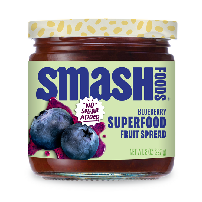 An 8 oz (227 g) jar of Smash Foods Superfood Jam - Raspberry with a green label featuring raspberries, dragon fruit, and “No Sugar Added!” text. This naturally sweetened superfood jam includes chia seeds.