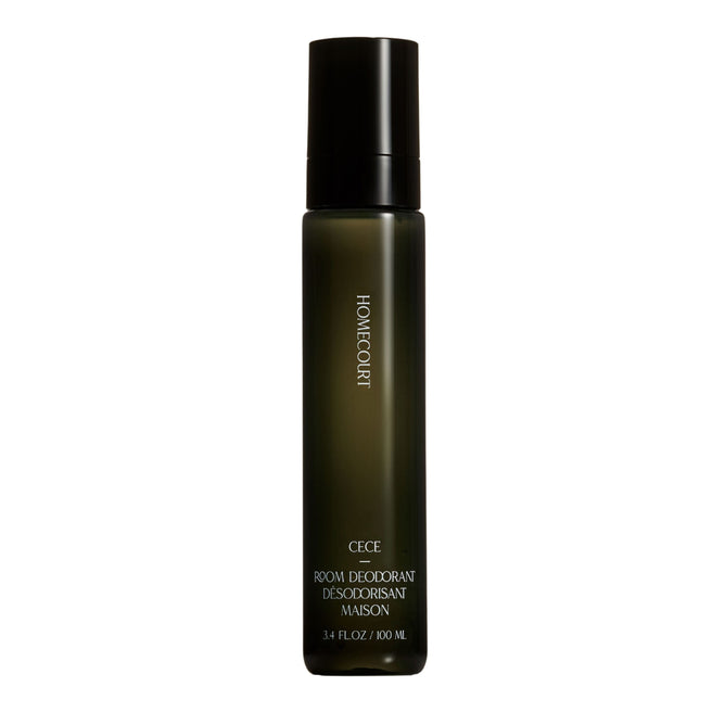 A dark green bottle of Homecourt Room Deodorant with a black cap and white text is shown against a white background.
