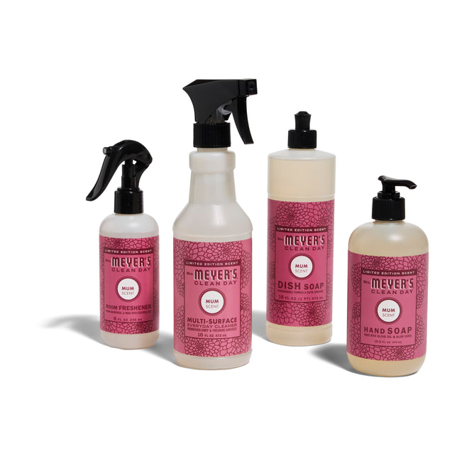 The Mrs. Meyers Autumn Breeze Cleaning Set - Mum includes four products—room freshener, multi-surface spray, dish soap, and hand soap—in clear plastic bottles with pink-patterned labels.