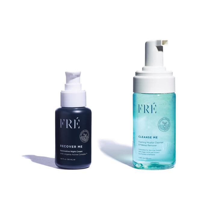 Two FRÉ Skincare products are displayed on a white background. On the left is the dark RECOVER ME Restorative Night Cream with Argania Active Complex™, featuring a pump. To its right sits a clear bottle containing light blue Cleanse Me micellar cleanser and makeup remover.