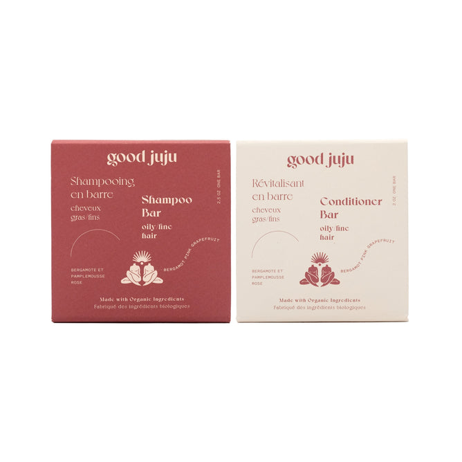 The Good Juju Body & Home Volumizing Haircare Set includes a red Volumizing Shampoo Bar and a cream Volumizing Conditioner Bar for oily, fine hair, both with rose graphics and bilingual English and French text.