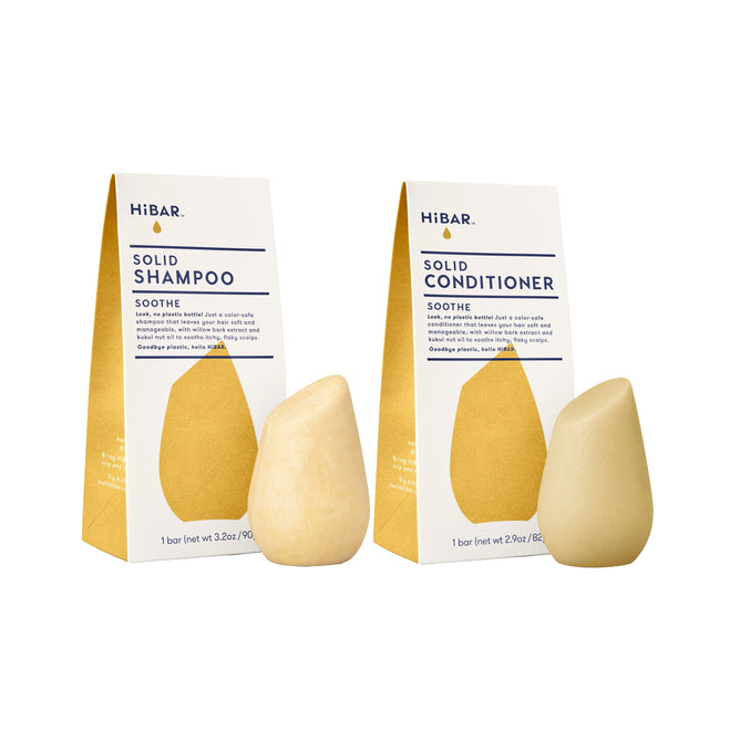 The HiBAR Soothe Haircare Set features uniquely shaped shampoo and conditioner bars in white and yellow “Soothe” packaging, displayed in front of their matching boxes.